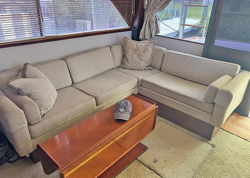 Slide: The Image of Cozy interior of 1988 Ocean Yachts 38 Super Sport with beige sofa and wooden table. - 17