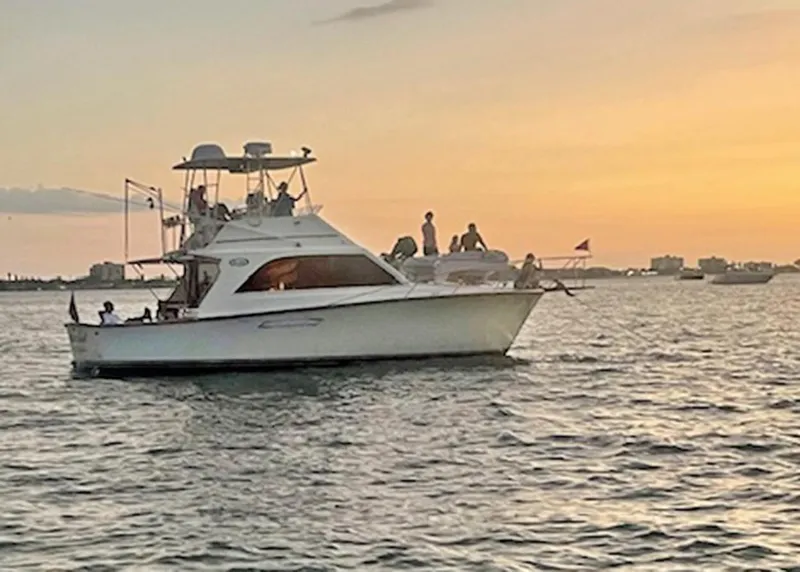 Slide: The Image of 1988 Ocean Yachts 38 Super Sport at sunset on the water. - 2