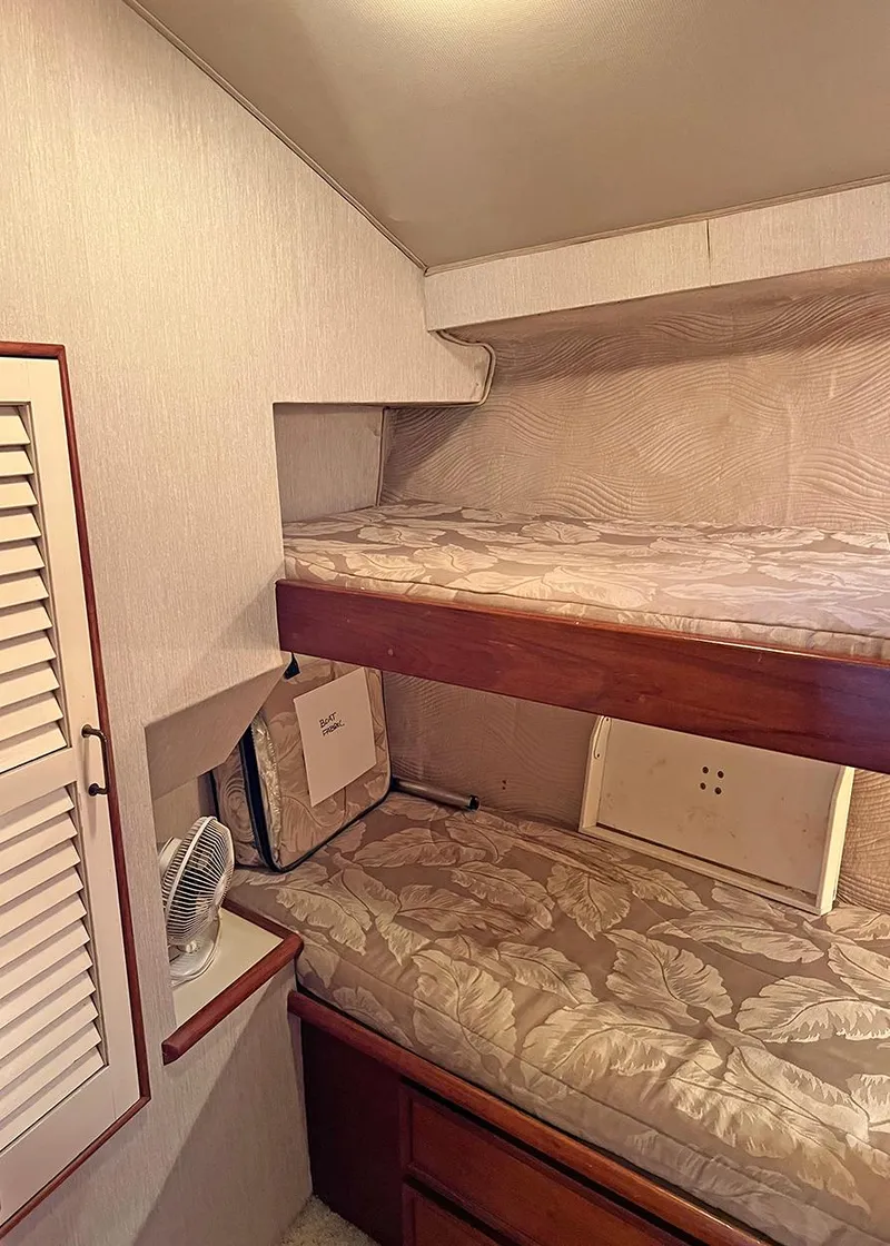 Slide: The Image of 1988 Ocean Yachts 38 Super Sport cabin with bunk beds and storage. - 21