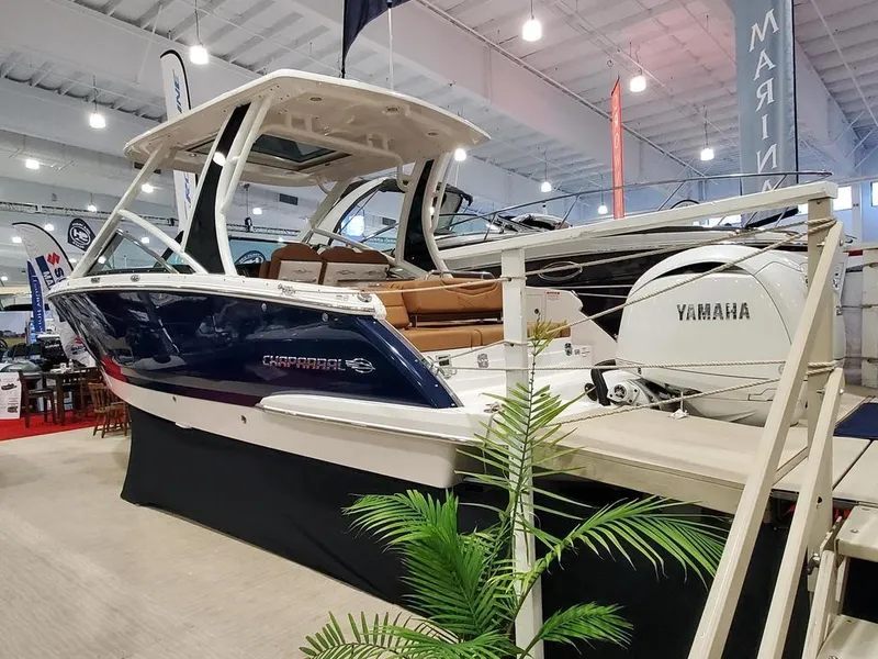 The Image of 2025 Chaparral 280 OSX boat displayed indoors with Yamaha engine. - 1