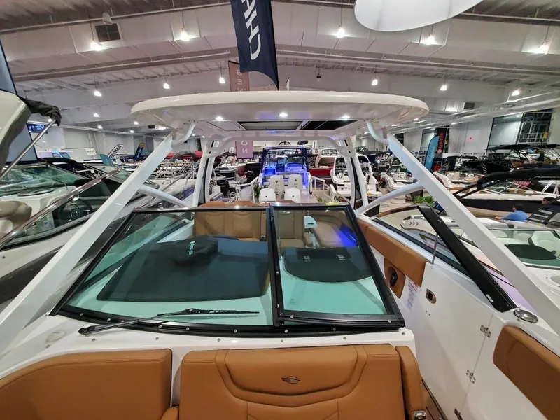 Slide: The Image of 2025 Chaparral 280 OSX boat interior at a showroom, featuring sleek design and modern amenities. - 10
