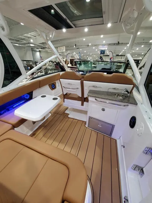 Slide: The Image of 2025 Chaparral 280 OSX boat interior with luxurious seating and modern amenities. - 4