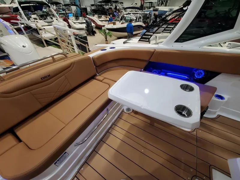 Slide: The Image of 2025 Chaparral 280 OSX boat interior with tan seating and white table. - 5
