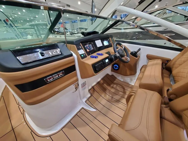 Slide: The Image of 2025 Chaparral 280 OSX boat interior with modern dashboard and luxurious seating. - 7