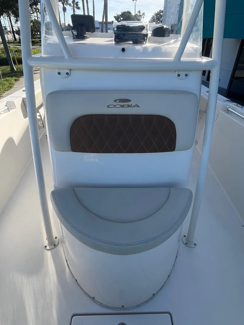 Slide: The Image of 2022 Cobia 237 Center Console boat interior with cushioned seating and console. - 3
