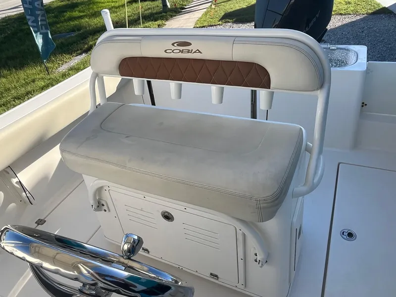 Slide: The Image of 2022 Cobia 237 Center Console boat seat with rod holders and storage. - 4