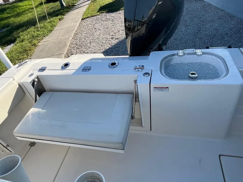 Slide: The Image of 2022 Cobia 237 Center Console boat with seating and sink on deck. - 6