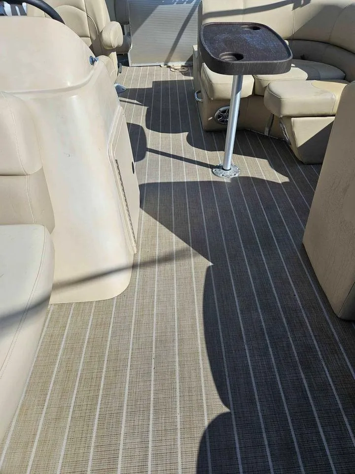 Slide: The Image of 2019 Manitou 22 Aurora LE 220VP Tritoon Pontoon interior with beige seating and striped flooring. - 12