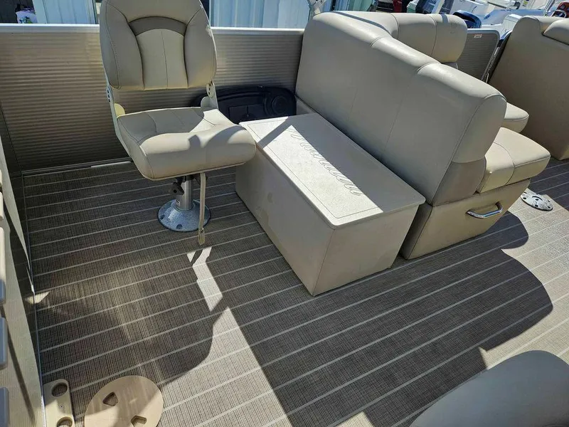 Slide: The Image of 2019 Manitou 22 Aurora LE 220VP Tritoon Pontoon interior with beige seating and flooring. - 6