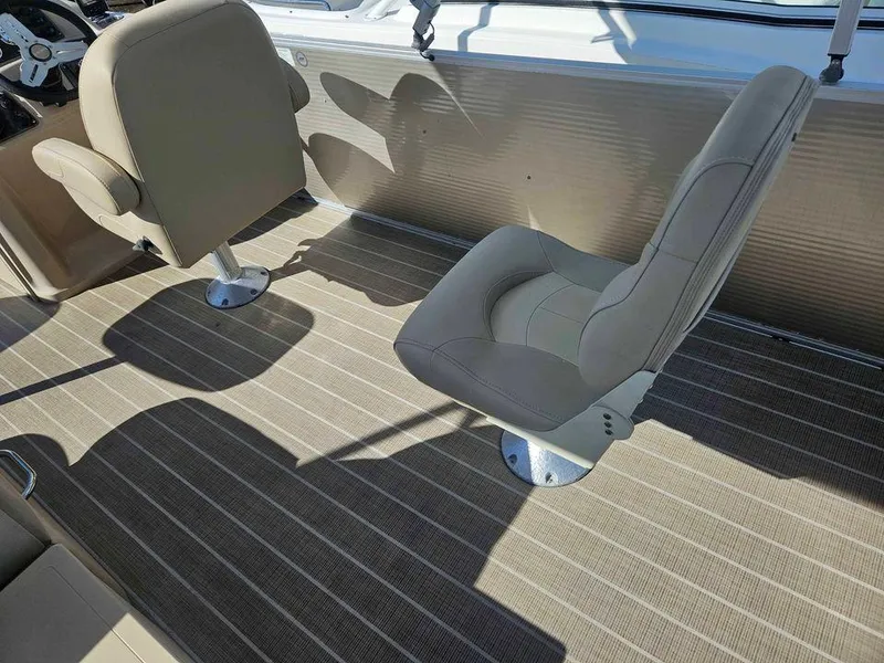 Slide: The Image of 2019 Manitou 22 Aurora LE 220VP Tritoon Pontoon interior with two beige seats. - 8