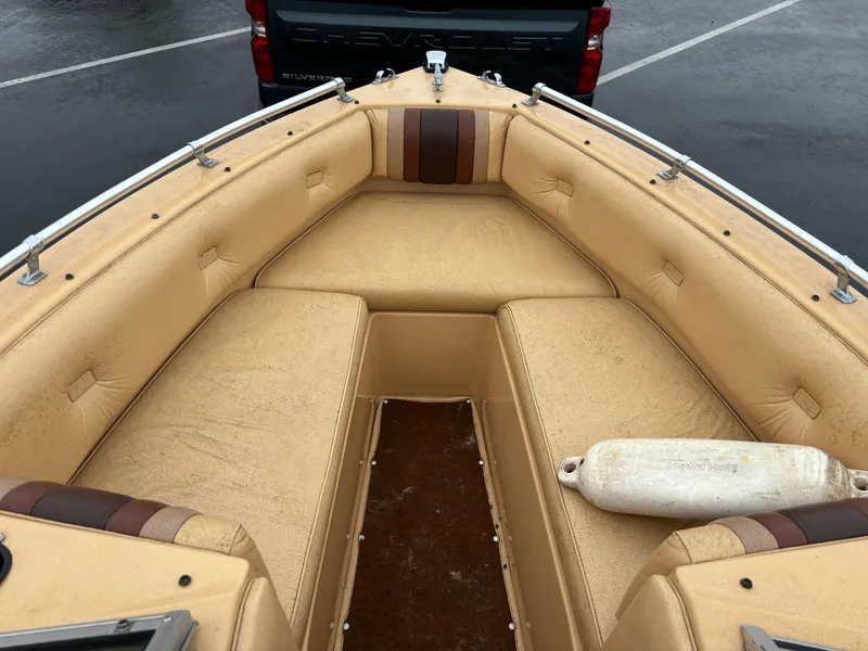 Slide: The Image of 1984 Chris-Craft 186 BR Scorpion boat interior with tan seating and a white fender. - 9