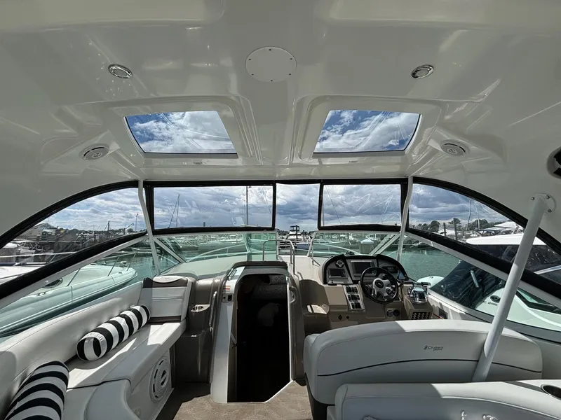 Slide: The Image of Interior of 2011 Cruisers Yachts 330 Express with panoramic windows and plush seating. - 12