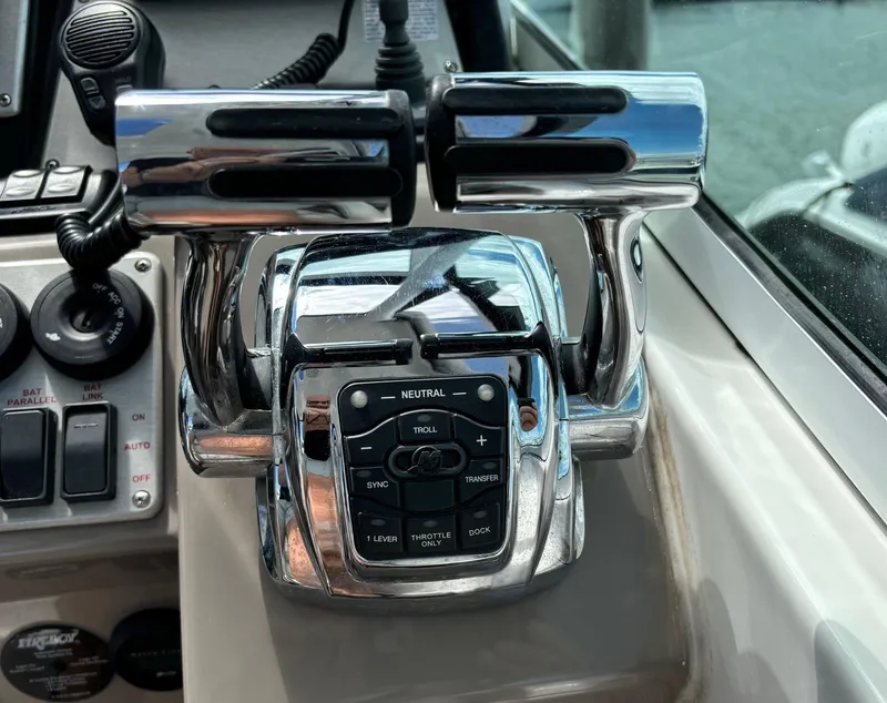Slide: The Image of Throttle controls on 2011 Cruisers Yachts 330 Express boat dashboard. - 15