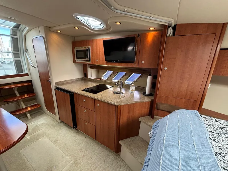 Slide: The Image of Luxurious 2011 Cruisers Yachts 330 Express interior with modern kitchen and cozy seating area. - 19