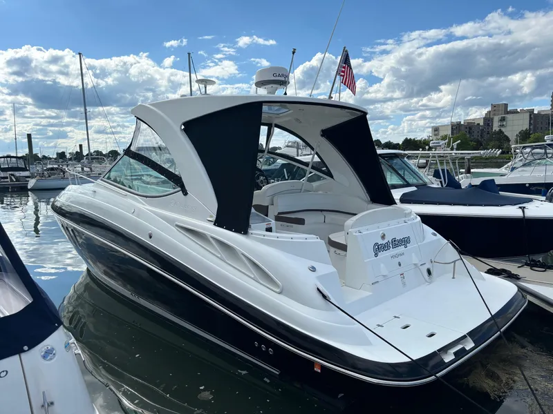 Slide: The Image of 2011 Cruisers Yachts 330 Express docked at marina under cloudy sky. - 2