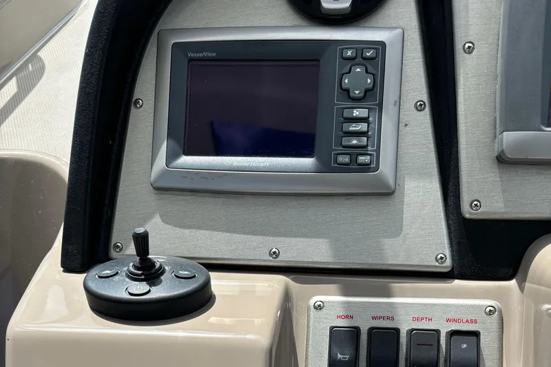 Slide: The Image of Control panel of 2011 Cruisers Yachts 330 Express with navigation display and joystick. - 22