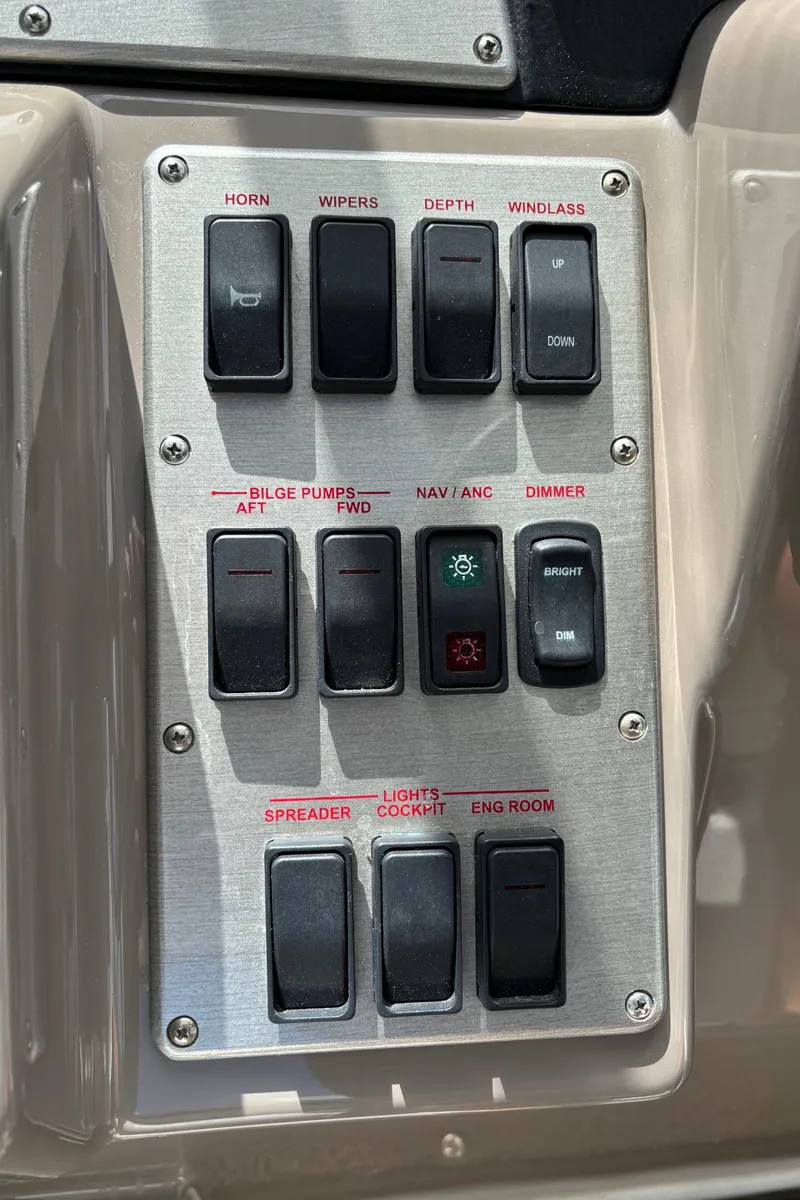 Slide: The Image of Control panel of 2011 Cruisers Yachts 330 Express with various switches and buttons. - 23
