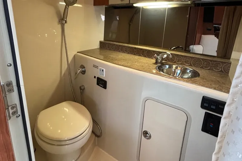 Slide: The Image of 2011 Cruisers Yachts 330 Express bathroom with sink, toilet, and showerhead. - 26