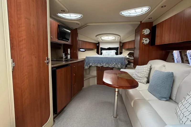 Slide: The Image of Luxurious interior of 2011 Cruisers Yachts 330 Express with cozy seating and elegant wood finishes. - 28
