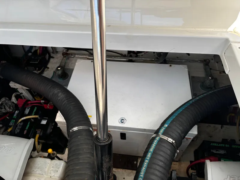 Slide: The Image of Engine compartment of 2011 Cruisers Yachts 330 Express with visible hoses and components. - 30