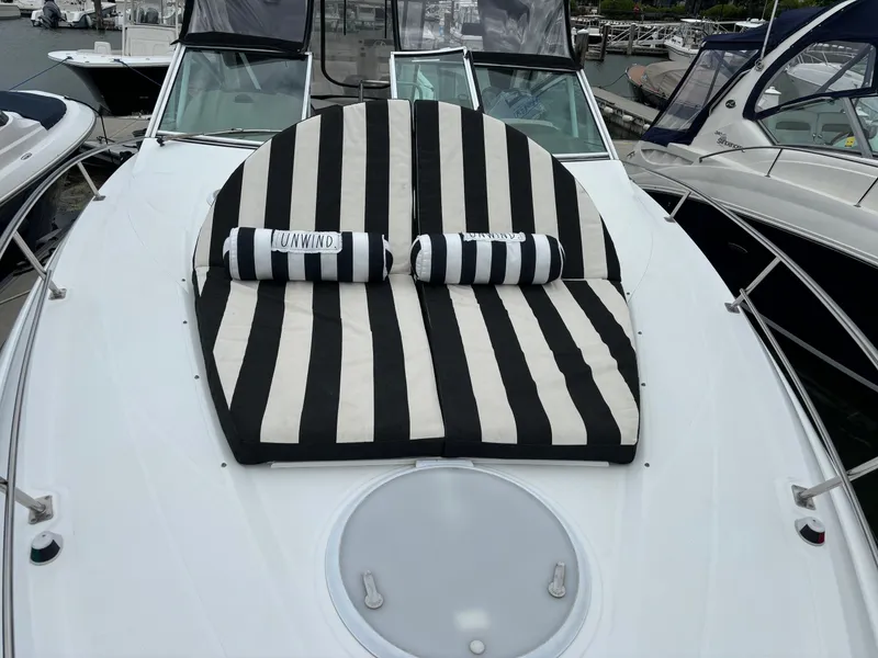 Slide: The Image of 2011 Cruisers Yachts 330 Express with striped sunbed on deck. - 5
