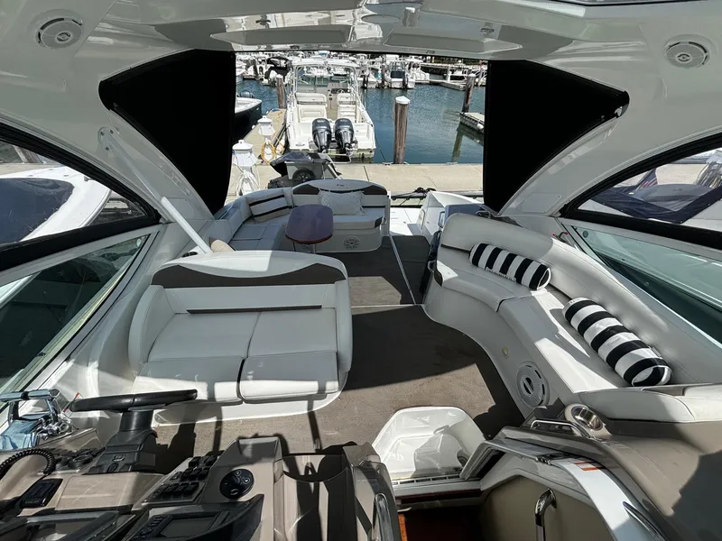 Slide: The Image of Luxurious 2011 Cruisers Yachts 330 Express interior with plush seating and marina view. - 11