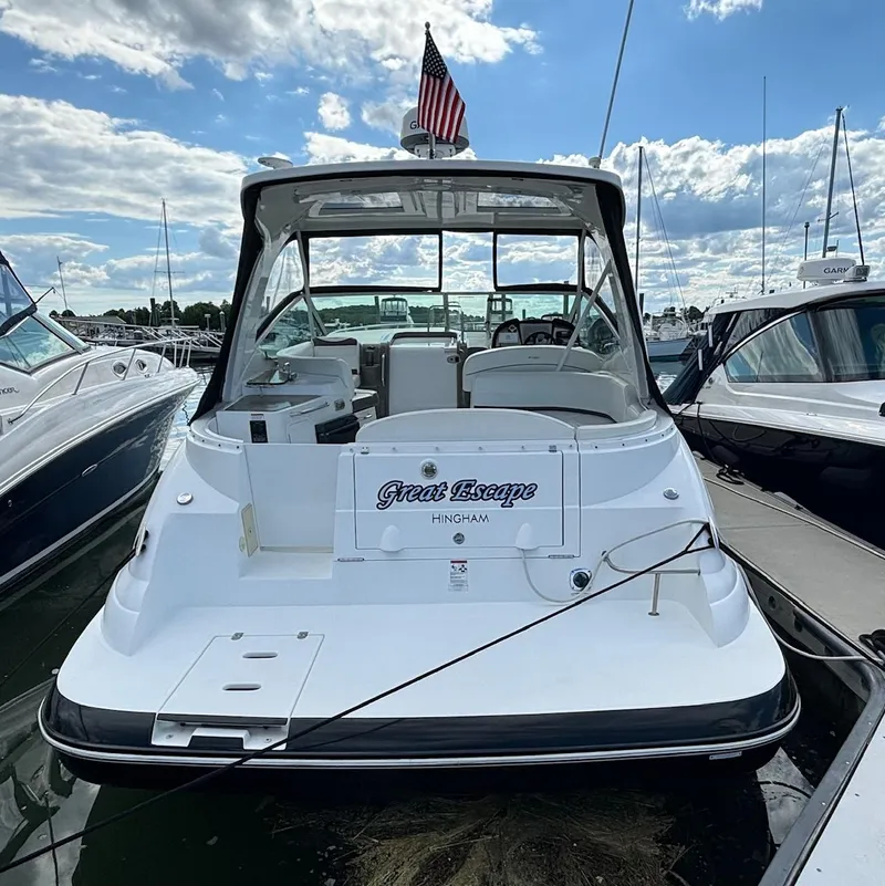 Slide: The Image of 2011 Cruisers Yachts 330 Express docked, rear view with American flag. - 3