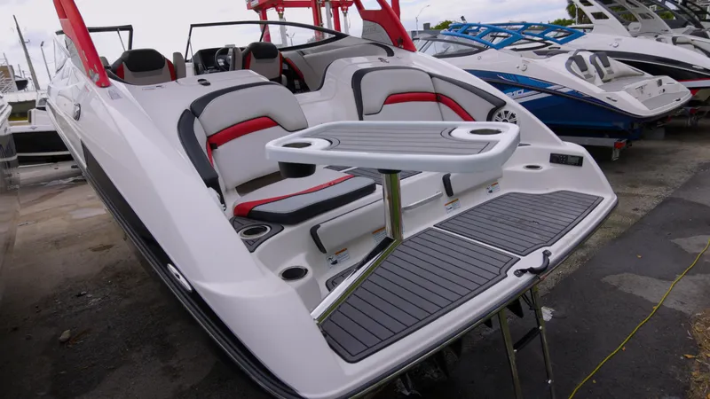 Slide: The Image of 2018 Yamaha Boats 242 XE with sleek seating and table setup. - 1