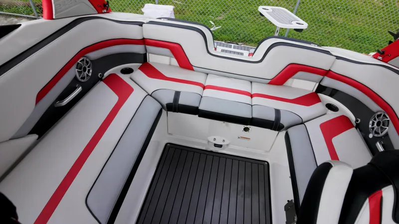 Slide: The Image of 2018 Yamaha Boats 242 XE interior with red and gray seating, modern design. - 2