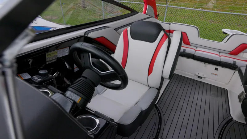 Slide: The Image of Interior of 2018 Yamaha Boats 242 XE, featuring sleek seating and modern steering wheel. - 6