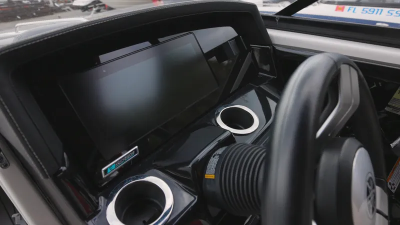 Slide: The Image of 2018 Yamaha Boats 242 XE dashboard with steering wheel and display screen. - 8