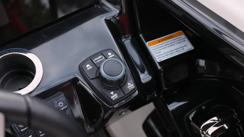 Slide: The Image of 2018 Yamaha Boats 242 XE control panel with cup holder and warning label. - 9