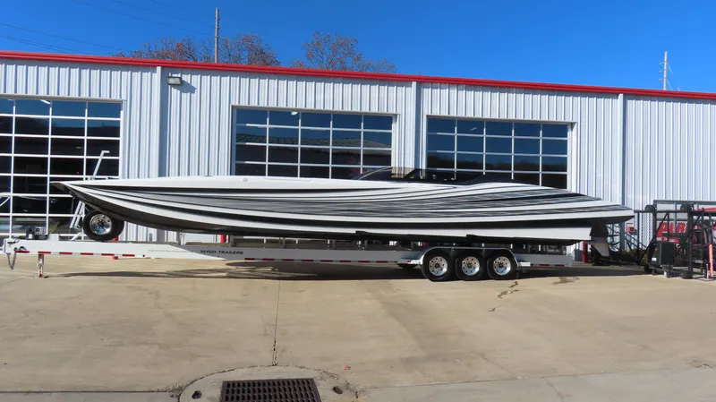 The Image of 2020 MTI 48 boat on trailer outside a garage. - 1