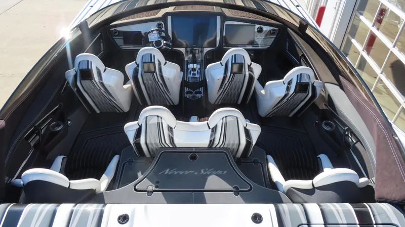 Slide: The Image of 2020 MTI 48 boat interior with six white seats and modern dashboard. - 16