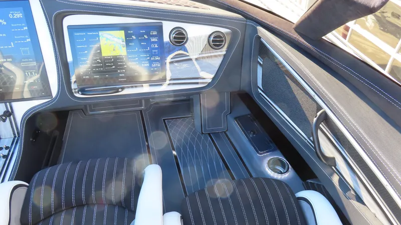 Slide: The Image of Interior of a 2020 MTI 48 boat with modern dashboard and navigation display. - 19