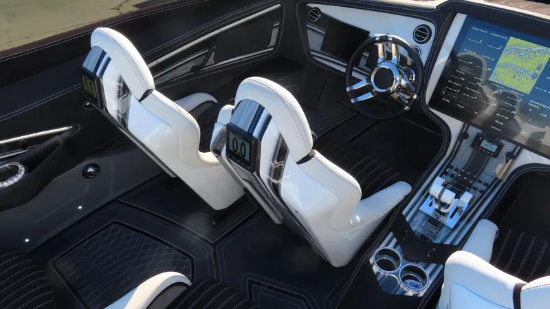 Slide: The Image of Interior of a 2020 MTI 48 boat with modern dashboard and white seats. - 29