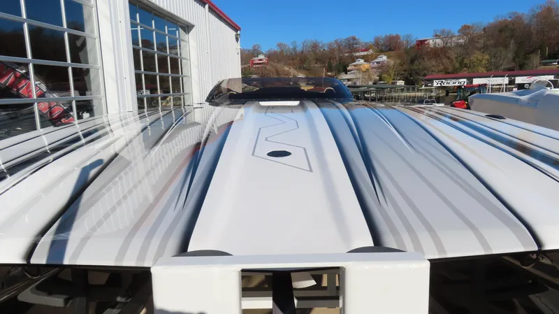 Slide: The Image of 2020 MTI 48 boat with sleek design and modern detailing, docked near a building. - 3