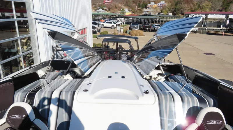 Slide: The Image of 2020 MTI 48 boat with open engine hatches, docked near a marina. - 31