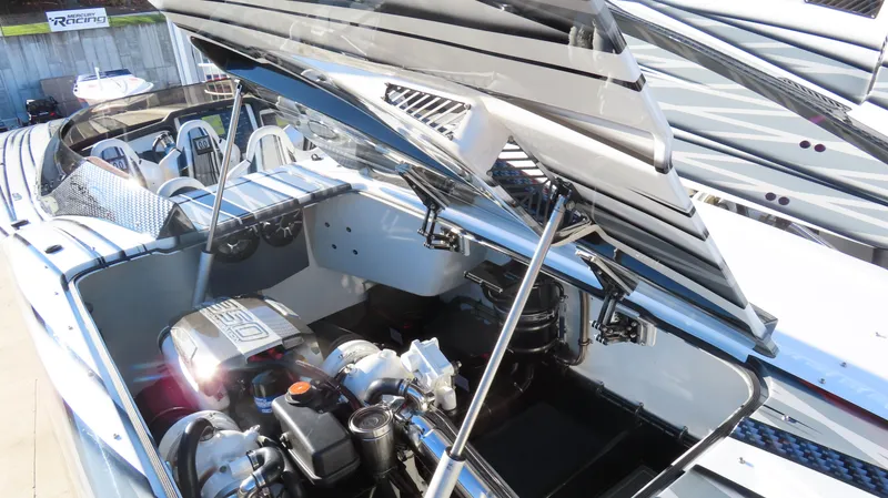Slide: The Image of 2020 MTI 48 boat engine compartment with open hatch, showcasing powerful engine components. - 41