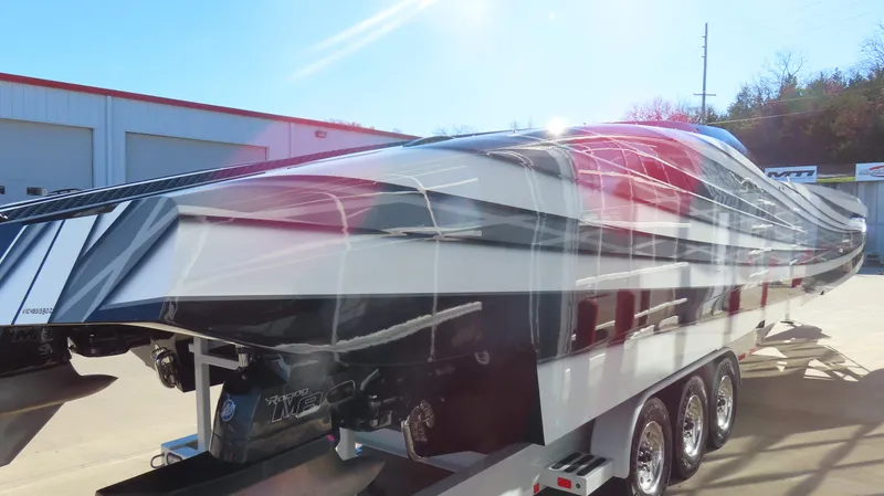Slide: The Image of 2020 MTI 48 powerboat on trailer, sleek design, parked outdoors. - 5