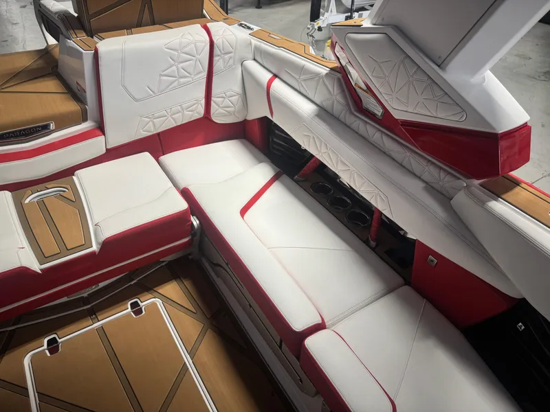 Slide: The Image of 2025 Nautique Super Air Nautique G23 Paragon interior with red and white seating, cup holders. - 11