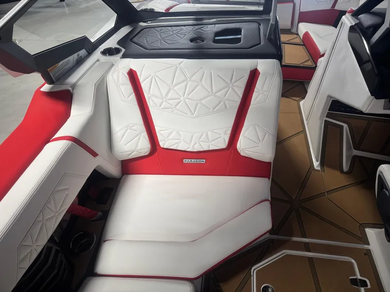 Slide: The Image of 2025 Nautique Super Air Nautique G23 Paragon interior with red and white seating. - 12