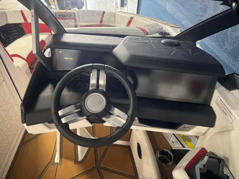 Slide: The Image of 2025 Nautique Super Air Nautique G23 Paragon steering wheel and dashboard interior. - 13