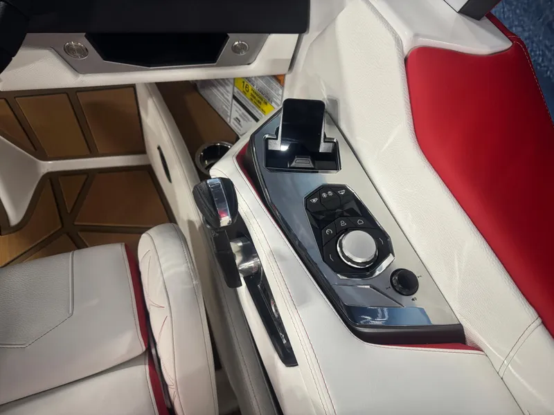Slide: The Image of 2025 Nautique Super Air Nautique G23 Paragon interior control panel with sleek design and red accents. - 14