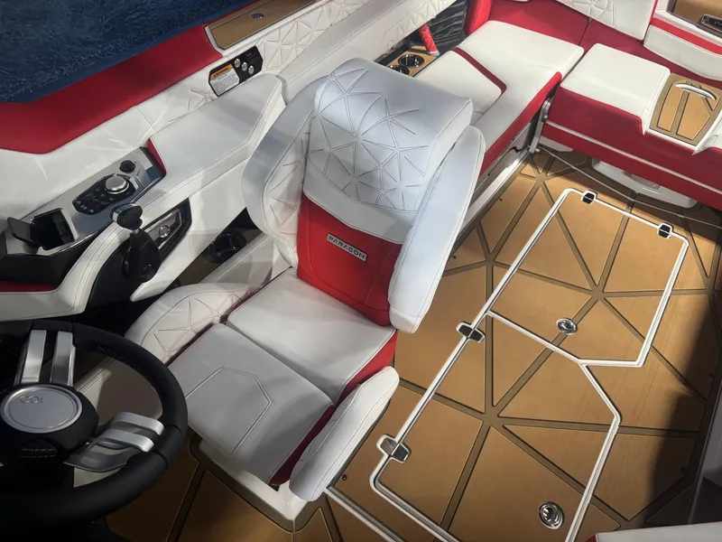 Slide: The Image of 2025 Nautique Super Air Nautique G23 Paragon interior with red and white seating, modern controls. - 15