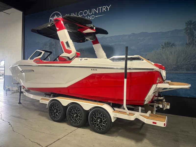Slide: The Image of 2025 Nautique Super Air Nautique G23 Paragon boat in showroom, red and white design. - 3