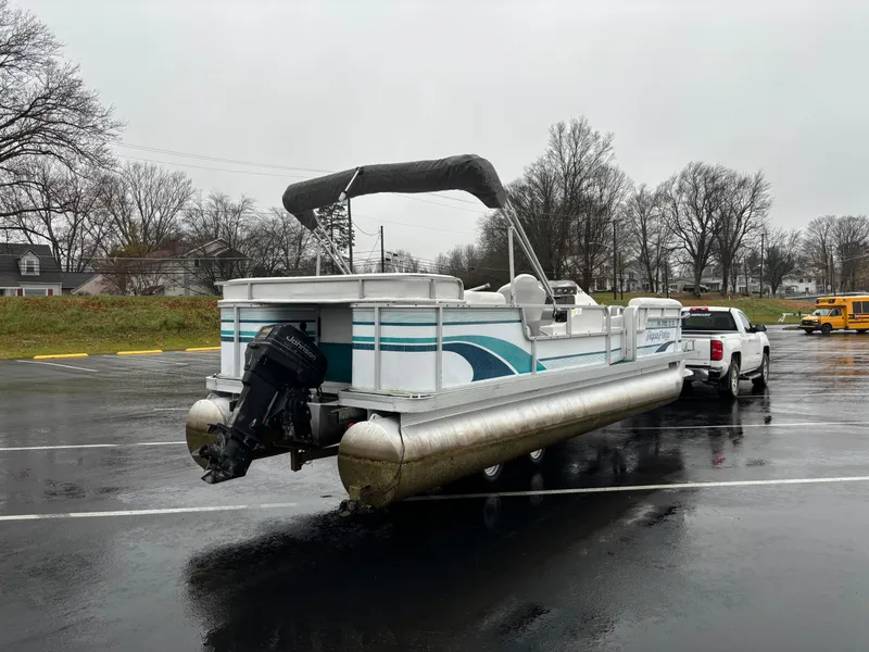 Slide: The Image of 1996 Godfrey Aqua Patio pontoon boat on trailer in parking lot. - 7