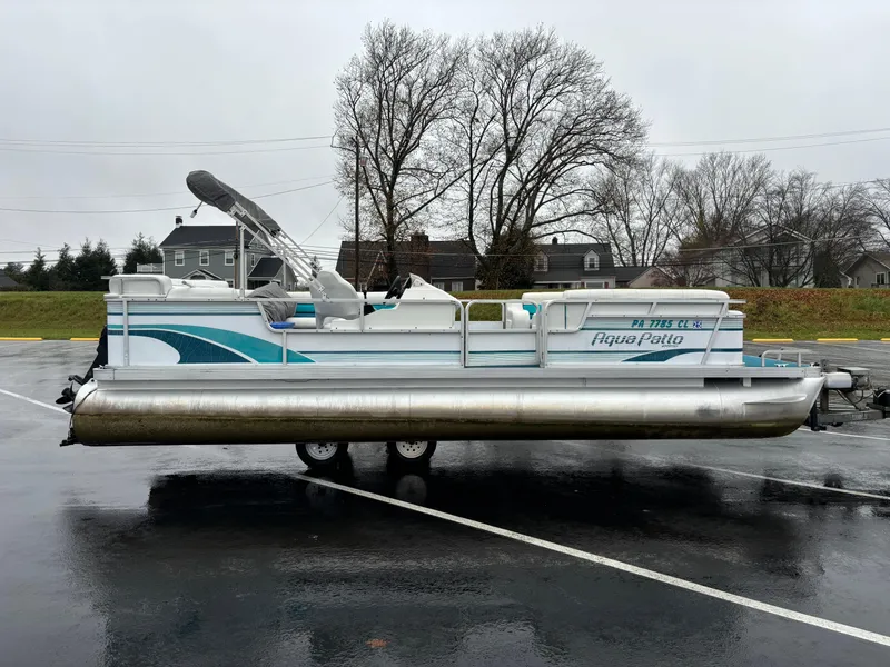 Slide: The Image of 1996 Godfrey Aqua Patio pontoon boat on wet pavement, overcast day. - 8