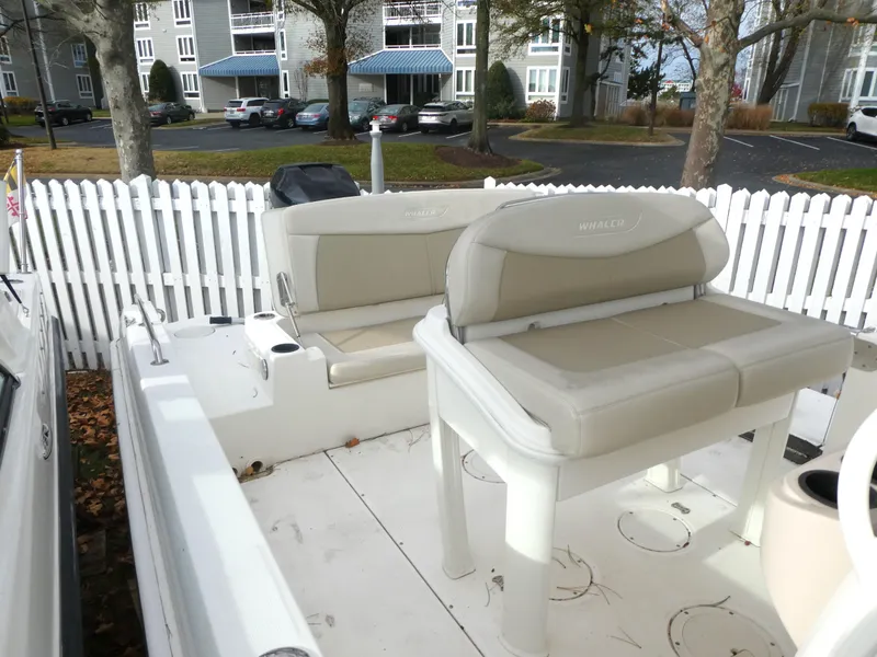 Slide: The Image of 2019 Boston Whaler 270 Dauntless boat interior with beige seating and white deck. - 10