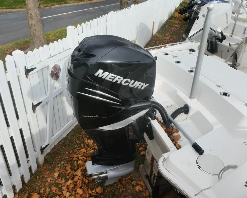 Slide: The Image of 2019 Boston Whaler 270 Dauntless with Mercury outboard engine, parked near white fence. - 11